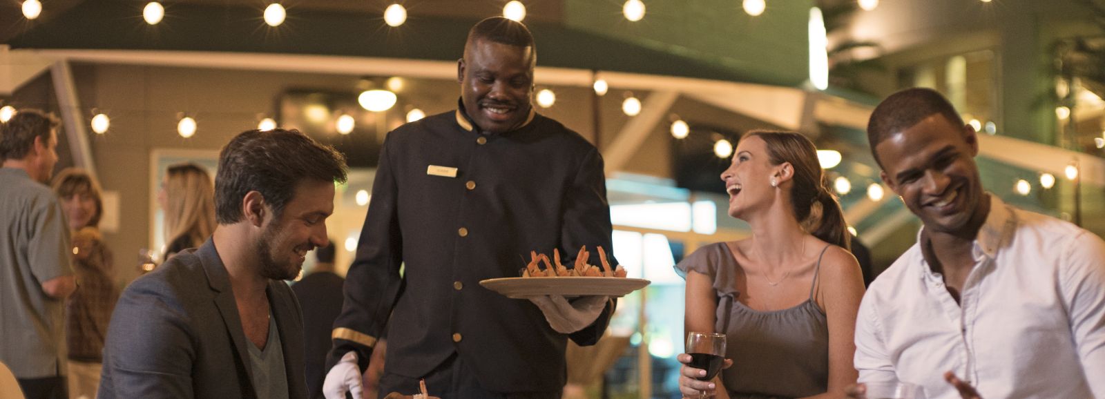 Server bringing food to guests